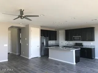 a kitchen with stainless steel appliances granite countertop a refrigerator and a stove top oven