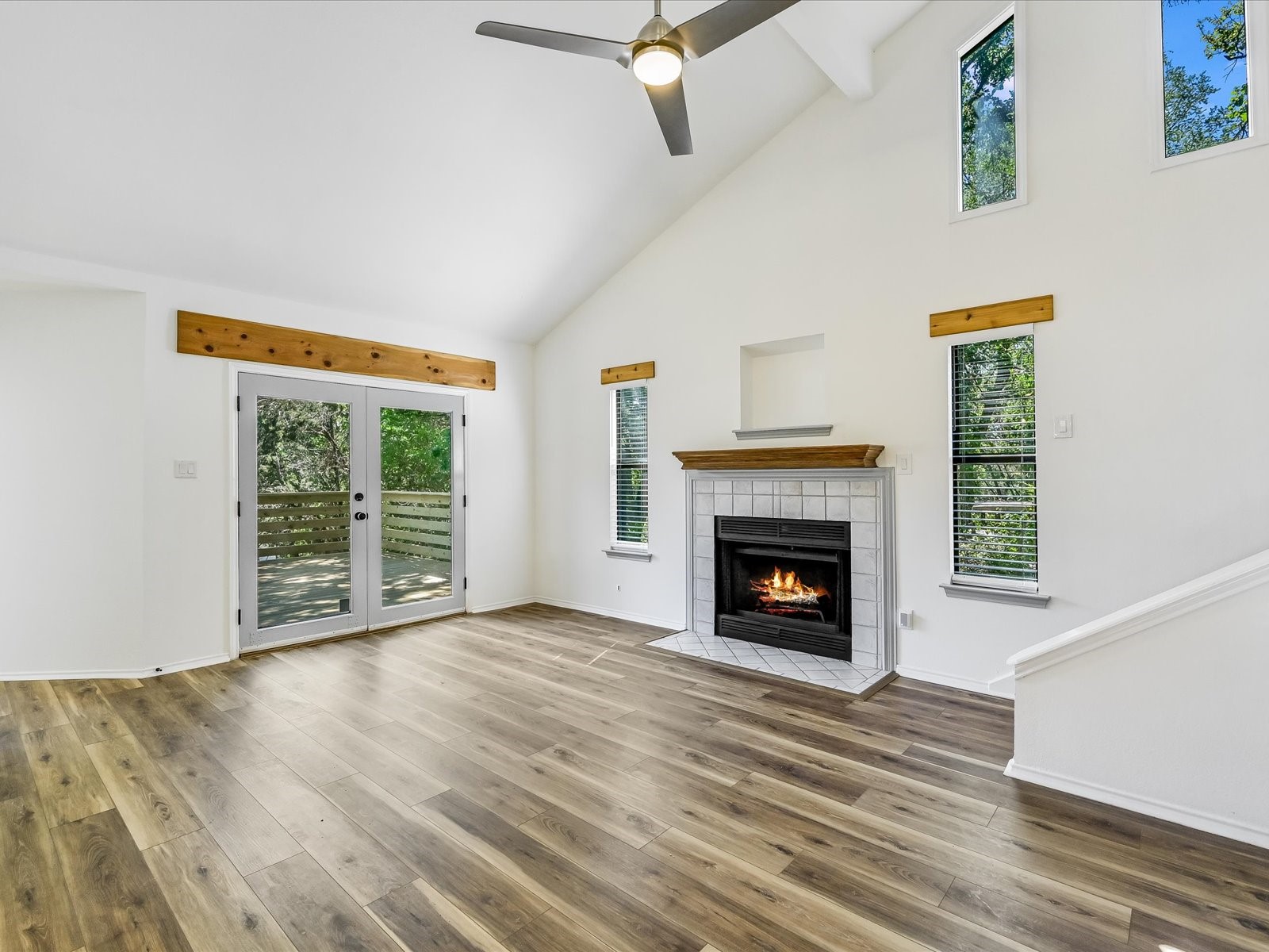 2712 Geronimo Trail Austin, TX 78734 - Photo 11 of 31 a view of an empty room with wooden floor fireplace and a window