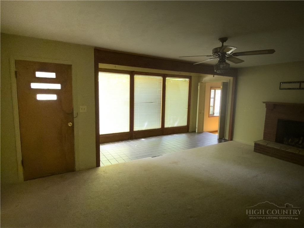 1205 Bamboo Road Boone, NC 28607 - Photo 13 of 17 a view of an empty room with a fireplace and a window