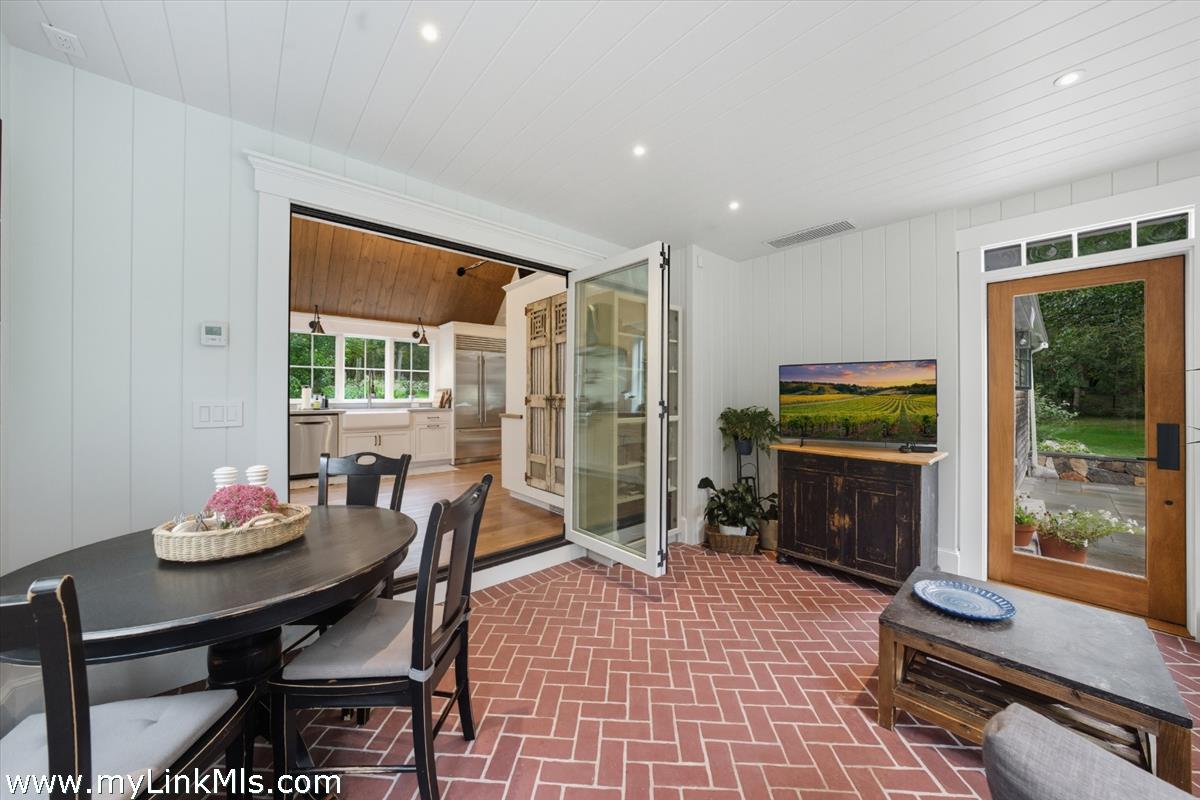 27 Clambelly Road Chilmark, MA 02535 - Photo 13 of 39 a living room with furniture a flat screen tv and a floor to ceiling window