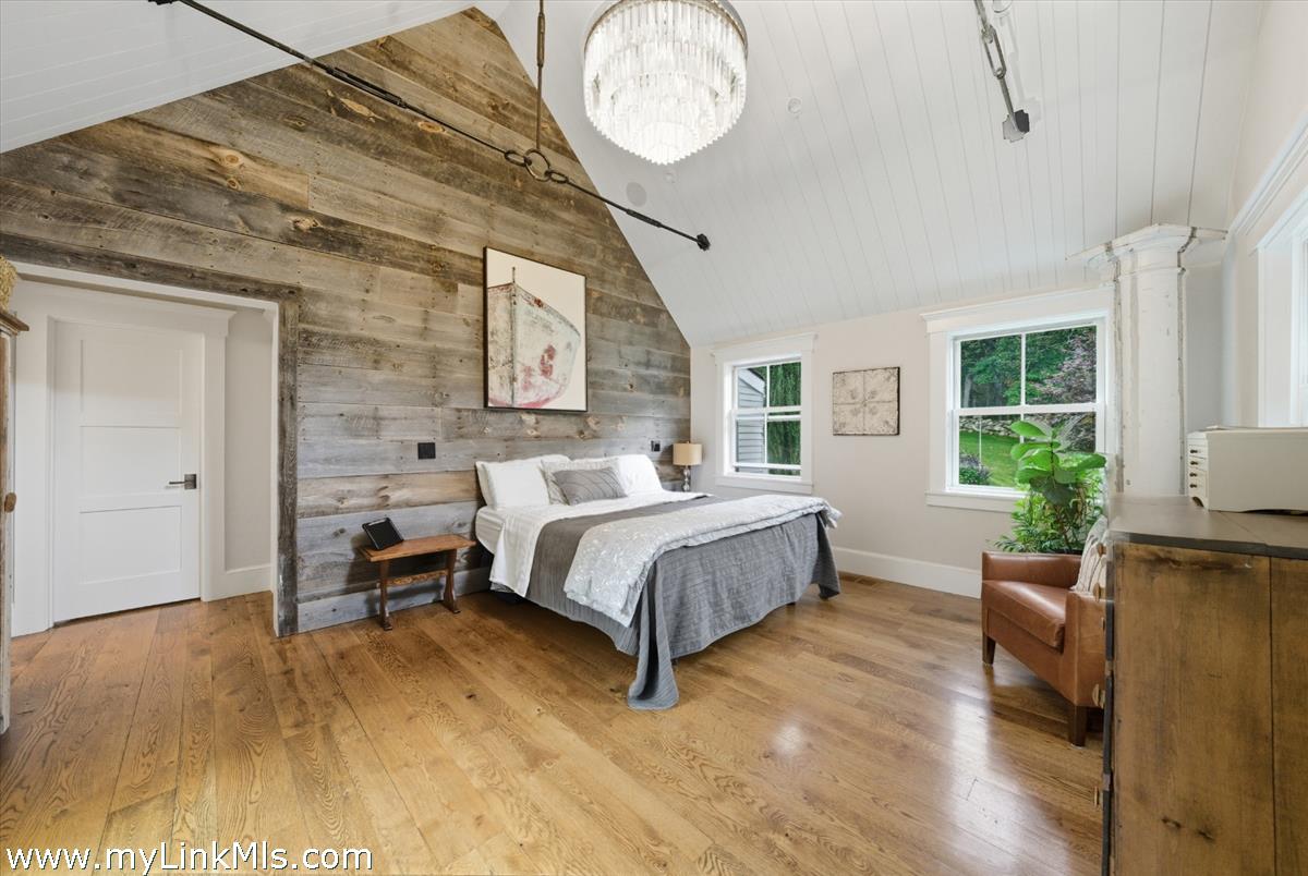 27 Clambelly Road Chilmark, MA 02535 - Photo 16 of 39 a spacious bedroom with a bed closet and a window