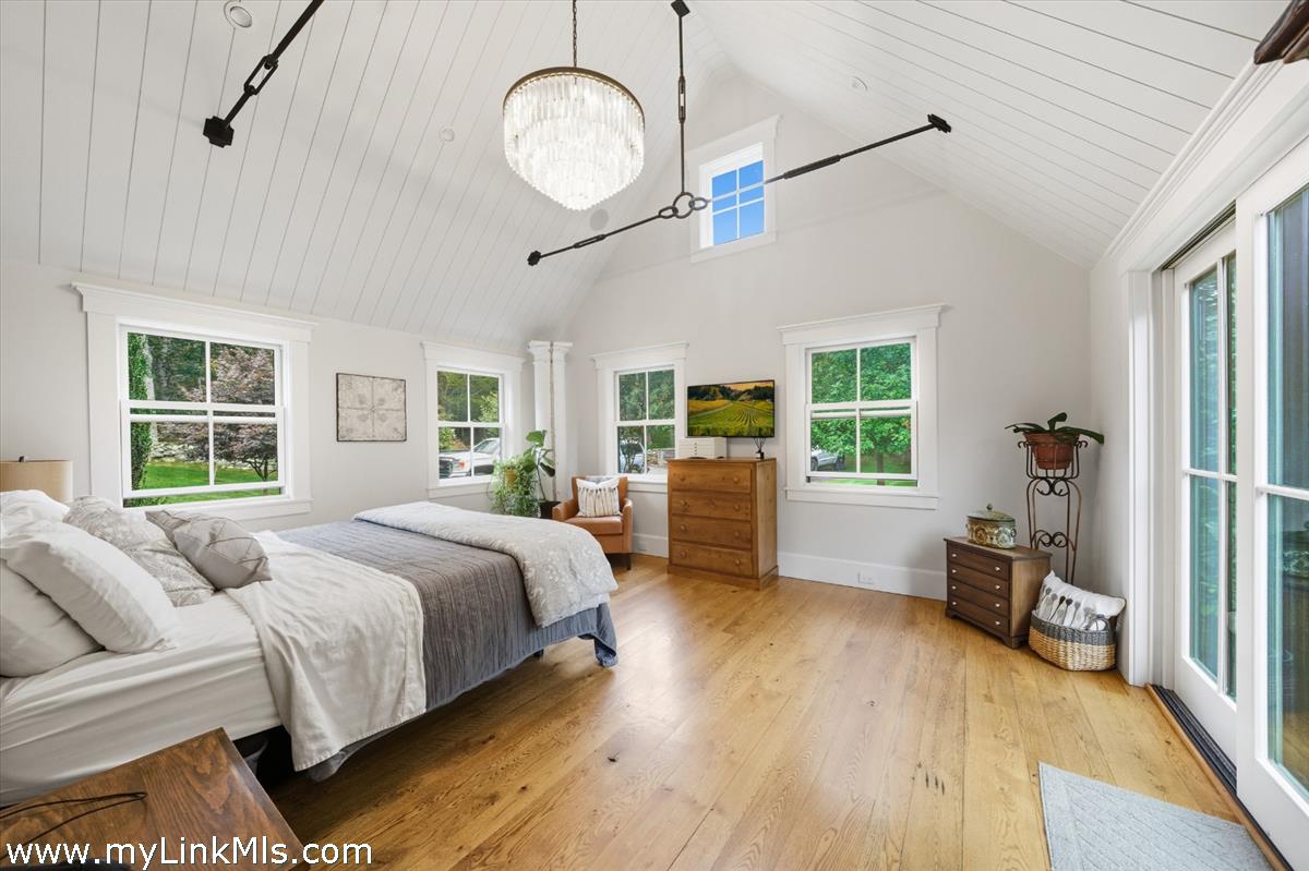 27 Clambelly Road Chilmark, MA 02535 - Photo 17 of 39 a spacious bedroom with a bed closet and a large window