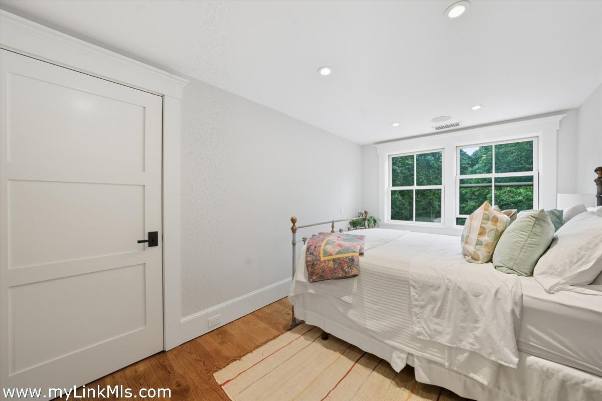 27 Clambelly Road Chilmark, MA 02535 - Photo 19 of 39 a bedroom with a bed and a large window