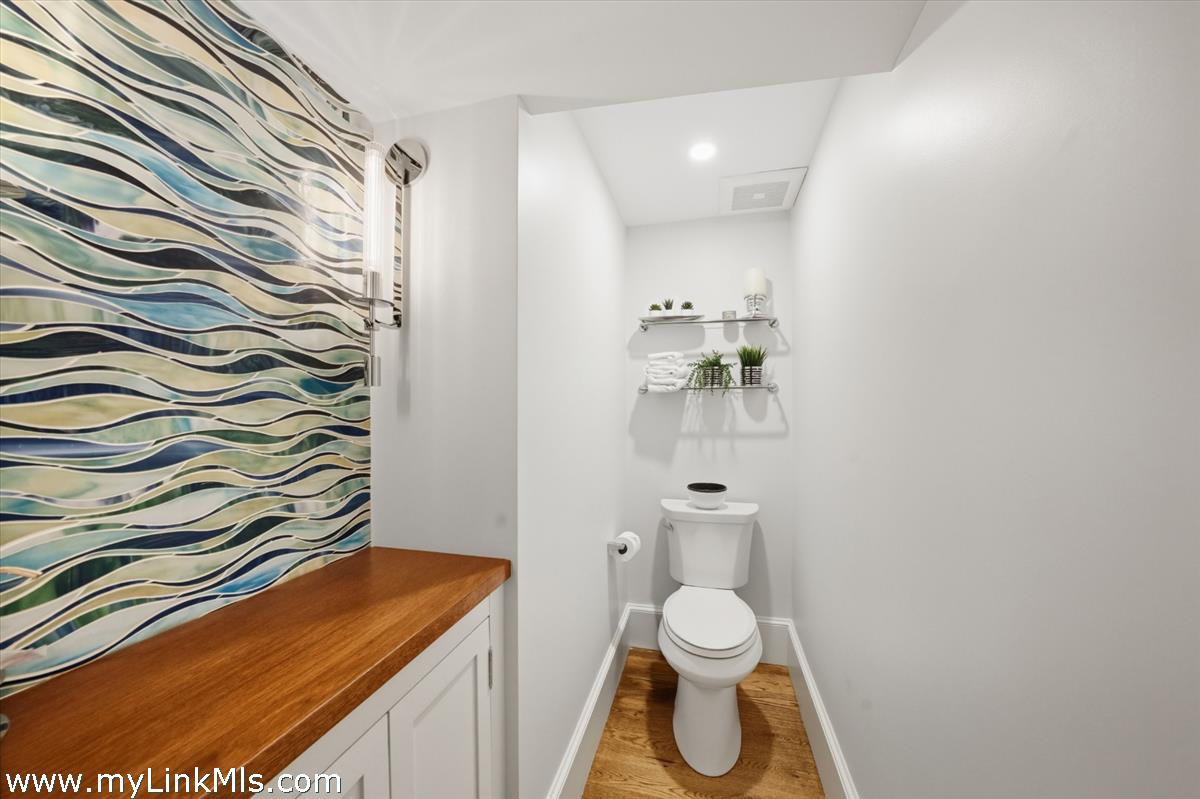 27 Clambelly Road Chilmark, MA 02535 - Photo 20 of 39 a bathroom with a toilet and a shower curtain