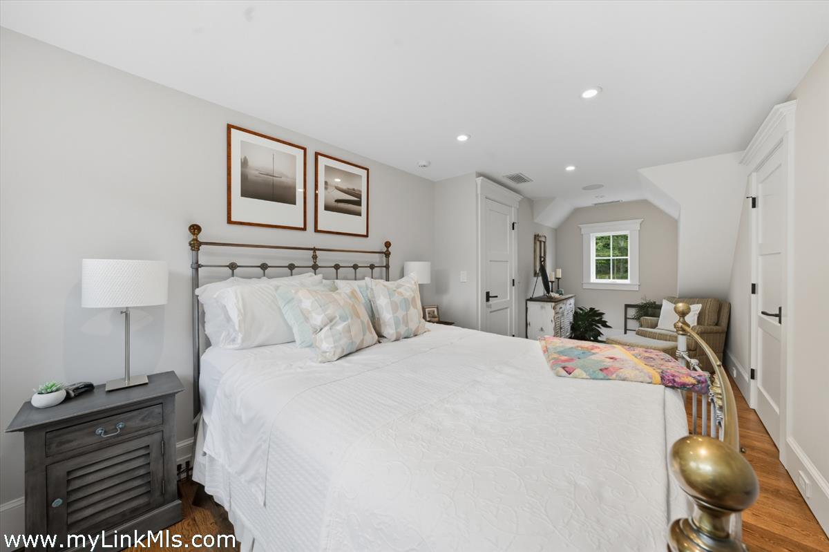 27 Clambelly Road Chilmark, MA 02535 - Photo 24 of 39 a bed room with a bed and a chair