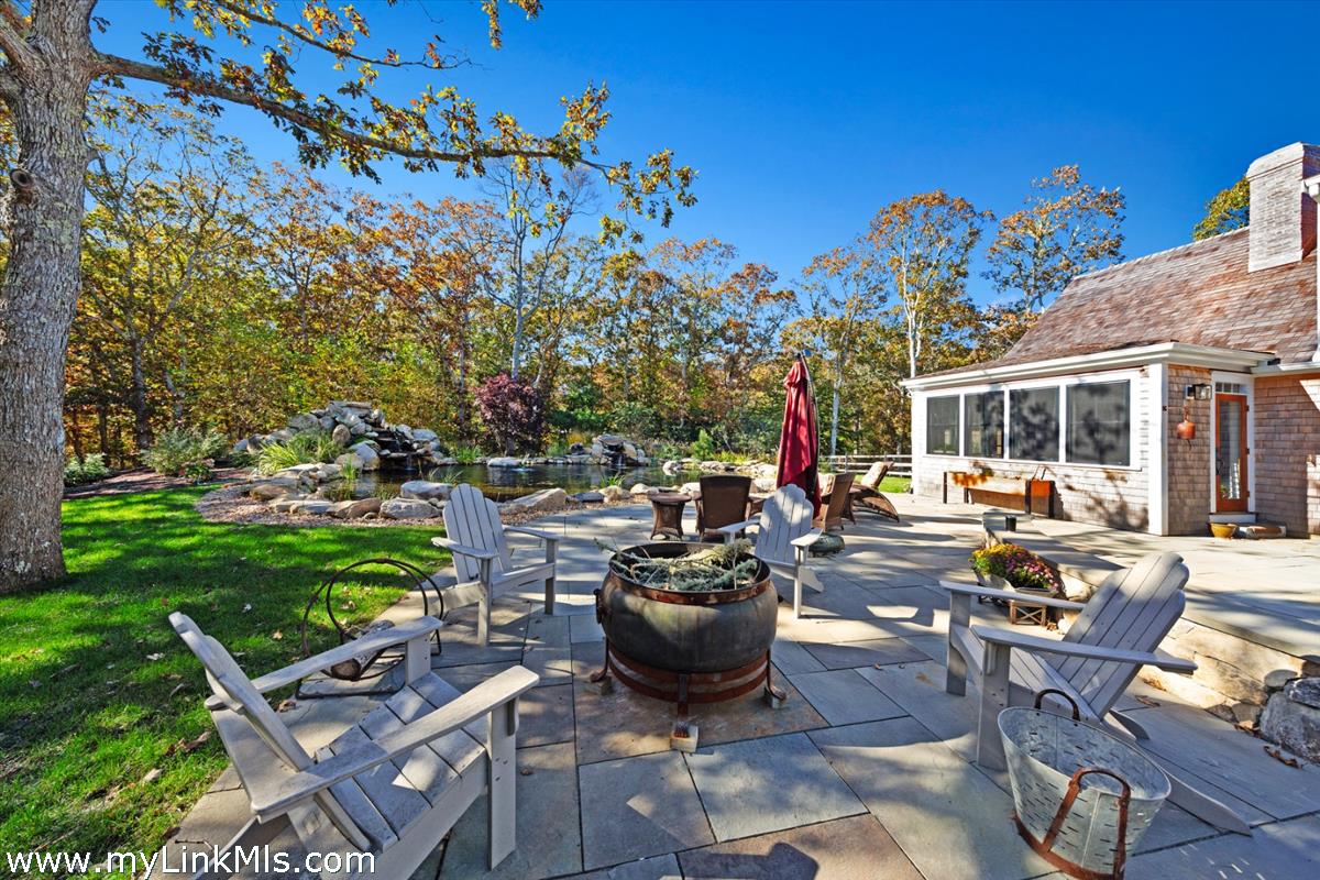 27 Clambelly Road Chilmark, MA 02535 - Photo 37 of 39 a view of a backyard with sitting area and furniture