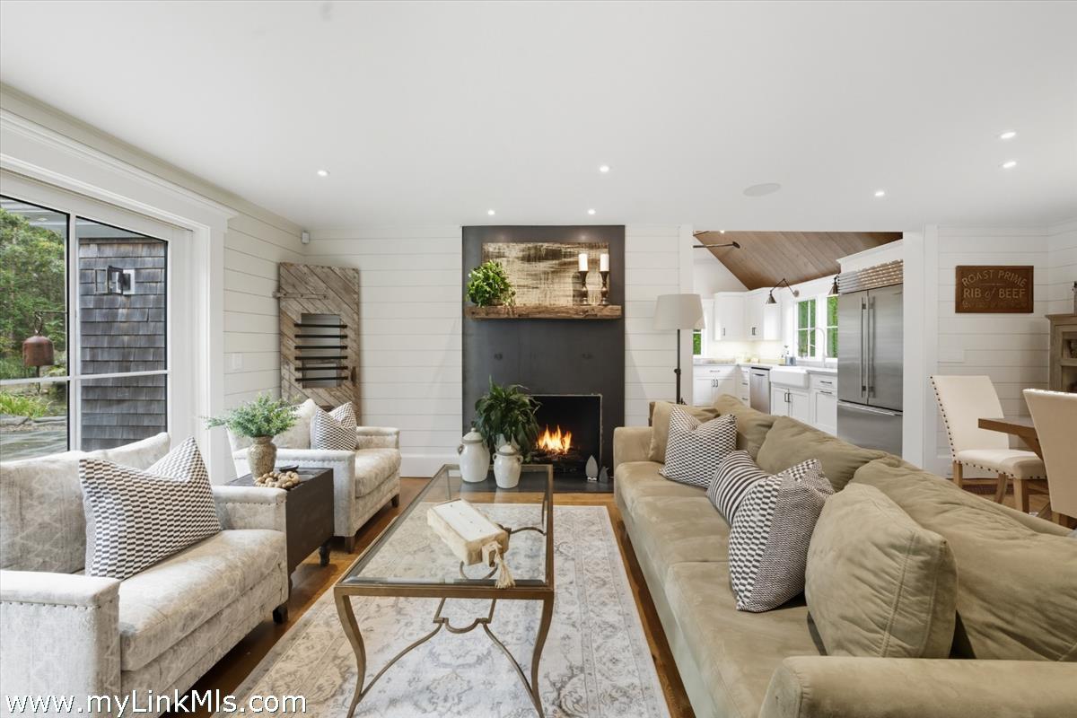 27 Clambelly Road Chilmark, MA 02535 - Photo 6 of 39 a living room with furniture fireplace and a large window