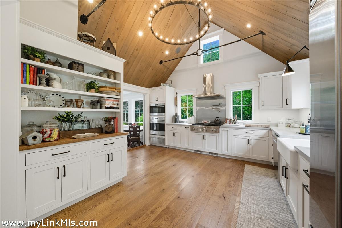 27 Clambelly Road Chilmark, MA 02535 - Photo 9 of 39 a large white kitchen with lots of counter space and wooden floor