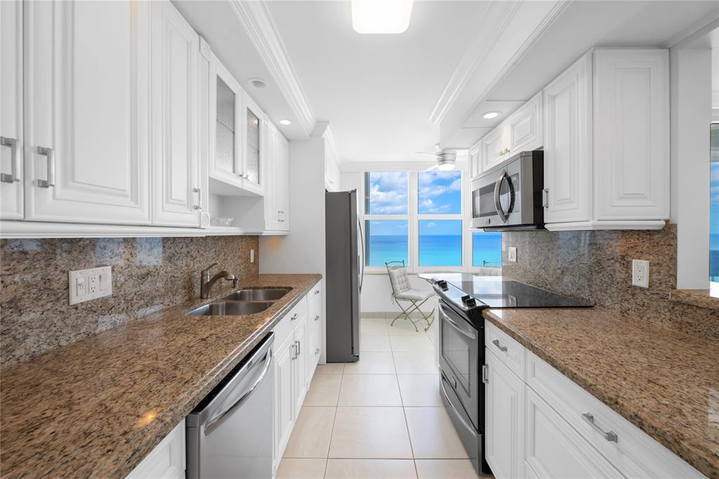 4280 Galt Ocean Drive, Unit 25C Fort Lauderdale, FL 33308 - Photo 2 of 55 a kitchen with stainless steel appliances granite countertop a sink stove and cabinets