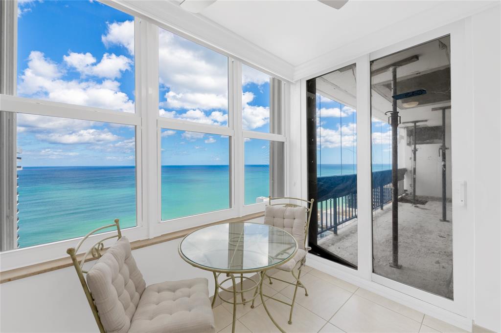 4280 Galt Ocean Drive, Unit 25C Fort Lauderdale, FL 33308 - Photo 4 of 55 a living room with a large window and table