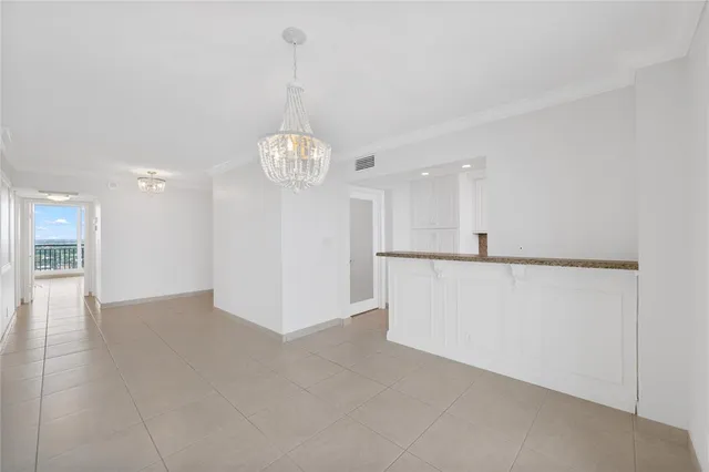 a view of a kitchen with a refrigerator and a chandelier