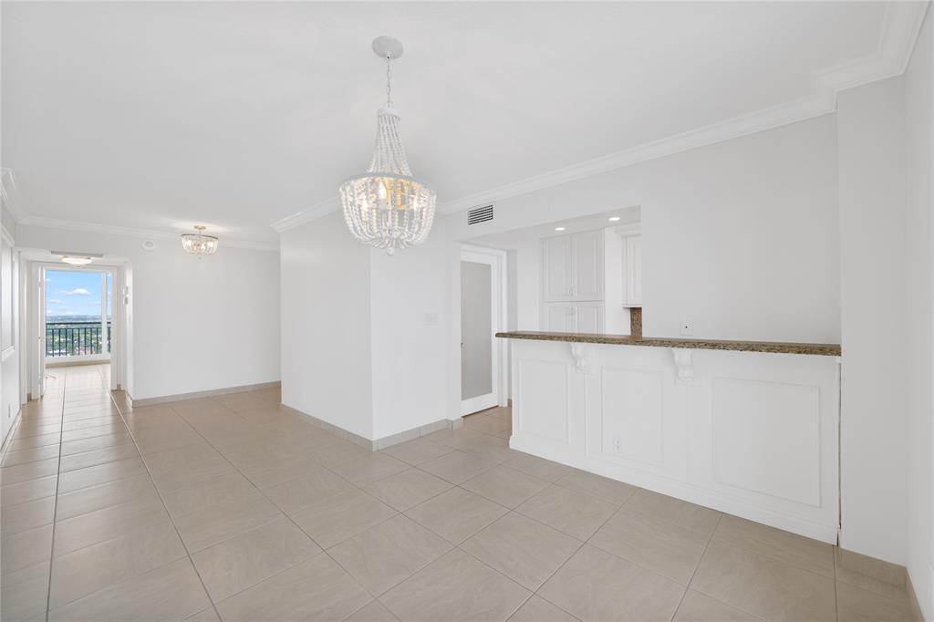 4280 Galt Ocean Drive, Unit 25C Fort Lauderdale, FL 33308 - Photo 10 of 55 a view of a kitchen with a refrigerator and a chandelier