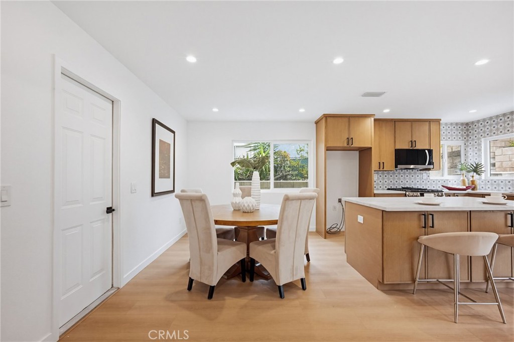 7355 Vineyard Avenue Rancho Cucamonga, CA 91730 - Photo 14 of 38 a view of a dining room with furniture a kitchen and chandelier