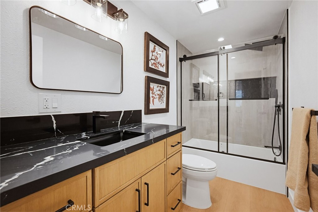 7355 Vineyard Avenue Rancho Cucamonga, CA 91730 - Photo 19 of 38 a bathroom with a toilet a sink and mirror