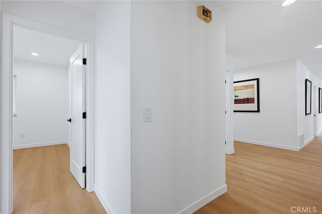 7355 Vineyard Avenue Rancho Cucamonga, CA 91730 - Photo 20 of 38 a view of a hallway with wooden floor