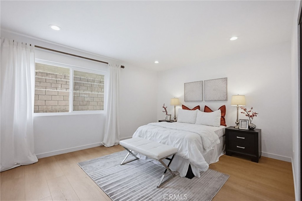 7355 Vineyard Avenue Rancho Cucamonga, CA 91730 - Photo 22 of 38 a bedroom with a bed and wooden floor