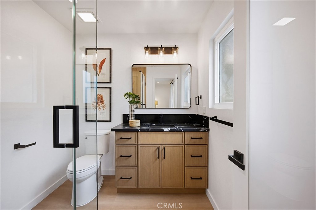 7355 Vineyard Avenue Rancho Cucamonga, CA 91730 - Photo 24 of 38 a bathroom with a toilet sink and mirror