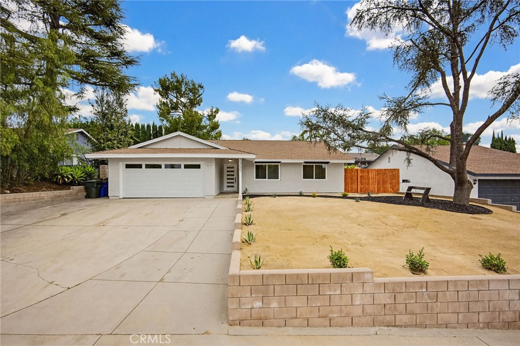 7355 Vineyard Avenue Rancho Cucamonga, CA 91730 - Photo 36 of 38 a front view of a house with a yard and garage