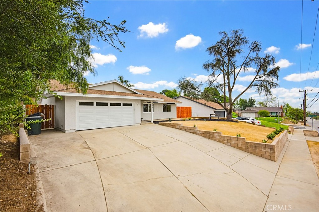 7355 Vineyard Avenue Rancho Cucamonga, CA 91730 - Photo 38 of 38 a white house with a large pool yard and palm trees