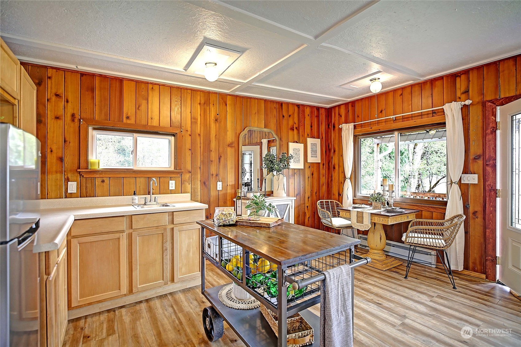 18818 Lerch Road Snohomish, WA 98290 - Photo 11 of 36 a dining hall with stainless steel appliances granite countertop a stove top oven a dining table and chairs with wooden floor