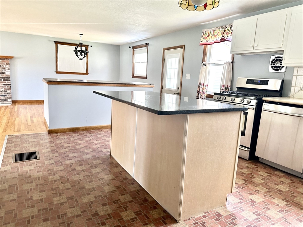 98 Corey Road Springfield, MA 01128 - Photo 5 of 24 a view of a kitchen with stainless steel appliances granite countertop a sink stove and cabinets