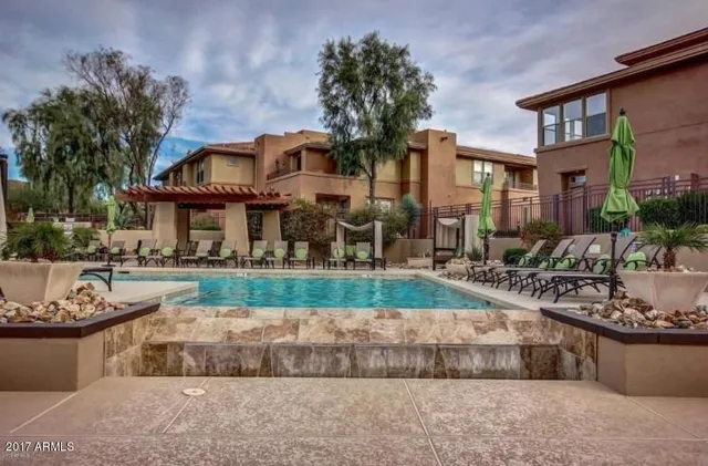 a front view of a house with a yard and fountain