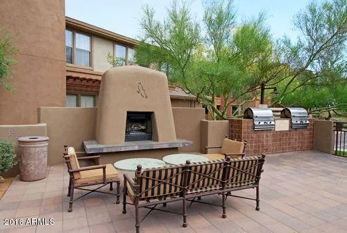 a view of a patio with a table and chairs