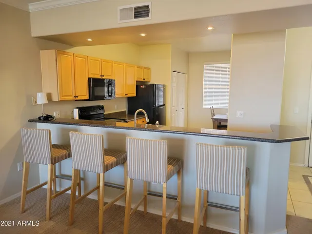 a kitchen with a sink cabinets and microwave