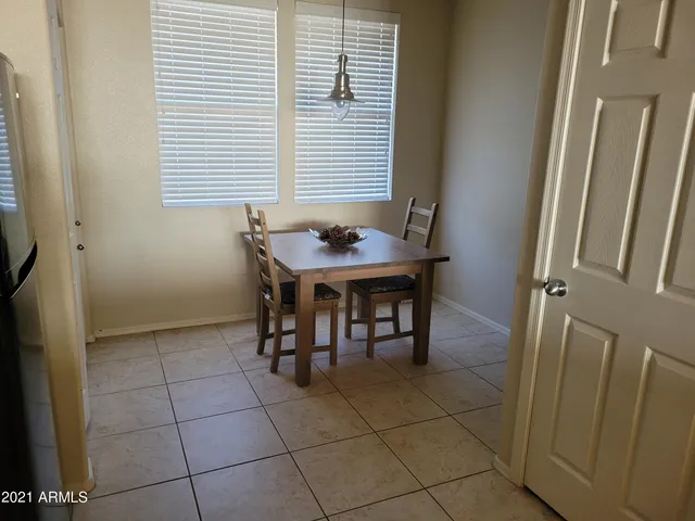 a view of a dining room with furniture and window