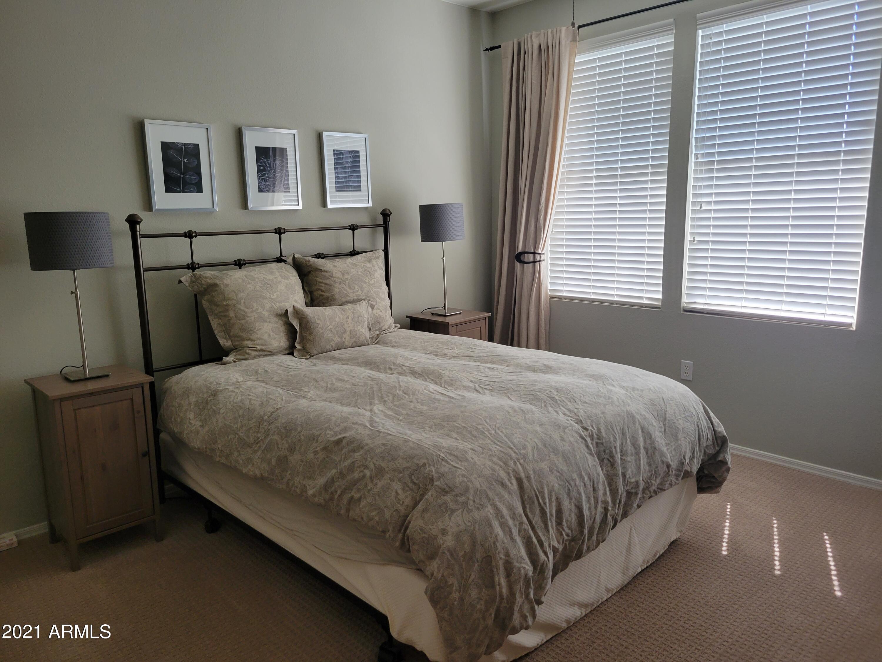 19777 North 76th Street, Unit 3186 Scottsdale, AZ 85255 - Photo 6 of 23 a large bed sitting in a bedroom next to a window