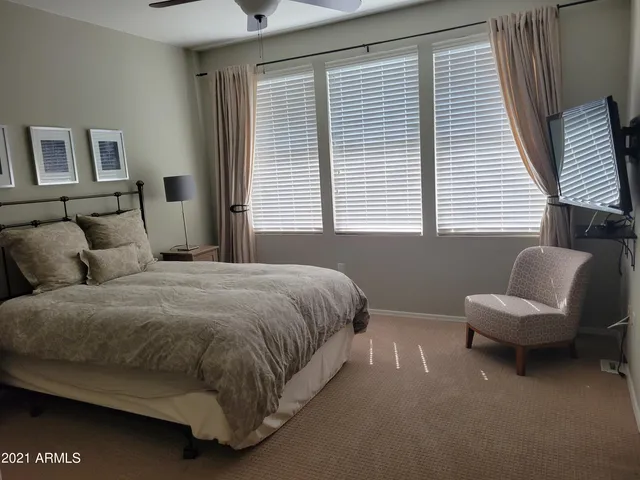 a spacious bedroom with a bed and a window