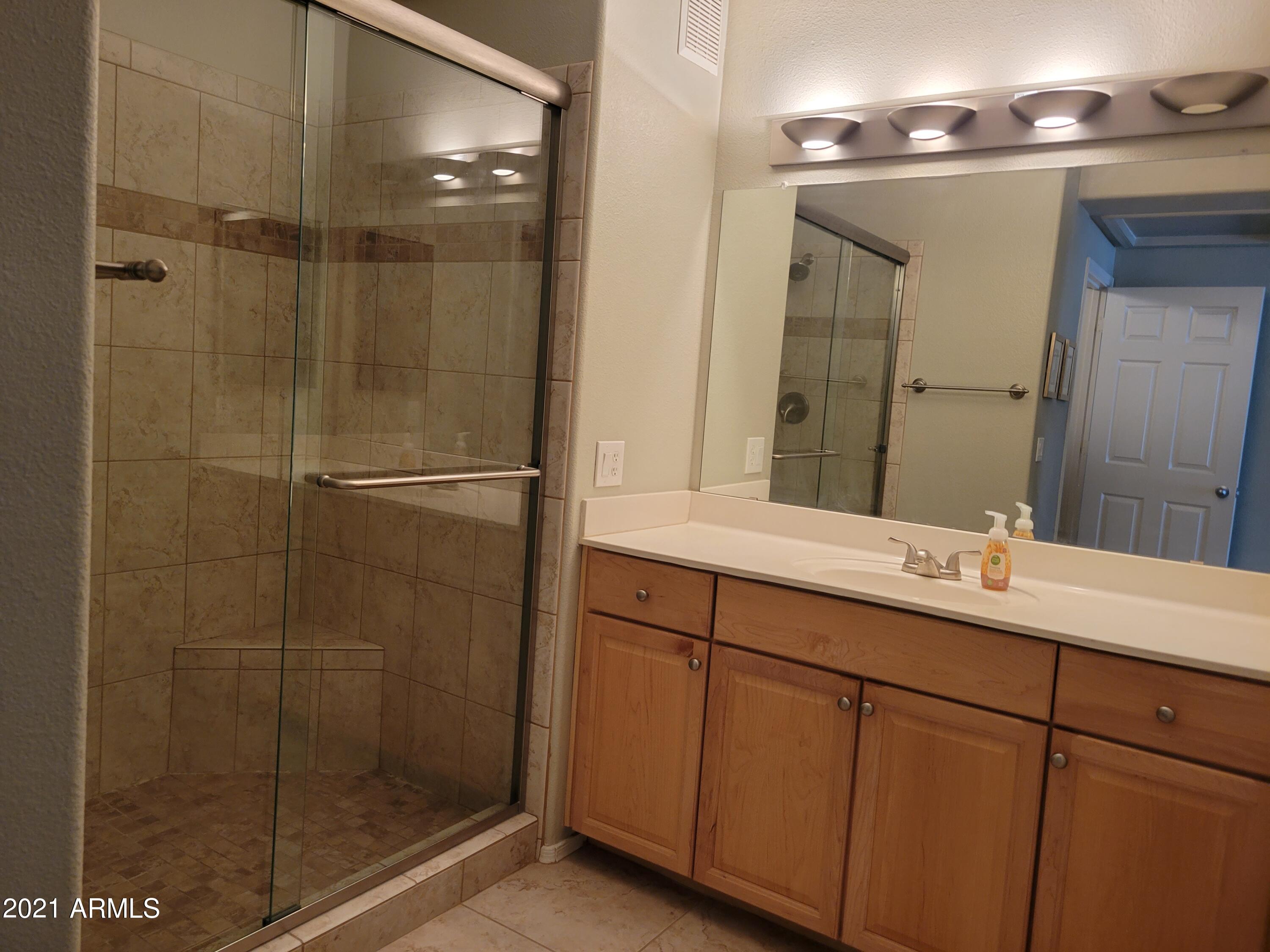 19777 North 76th Street, Unit 3186 Scottsdale, AZ 85255 - Photo 8 of 23 a bathroom with a shower sink and mirror