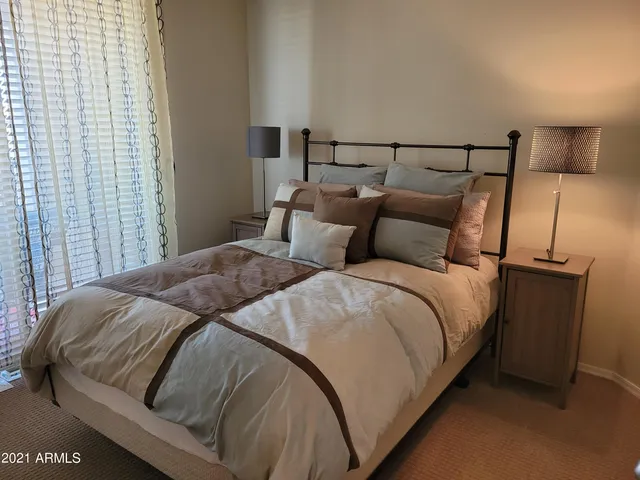 a bedroom with a bed and a night stand