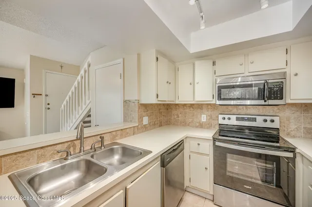 a kitchen with a sink stove and microwave