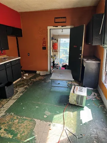a living room with fireplace furniture and rug