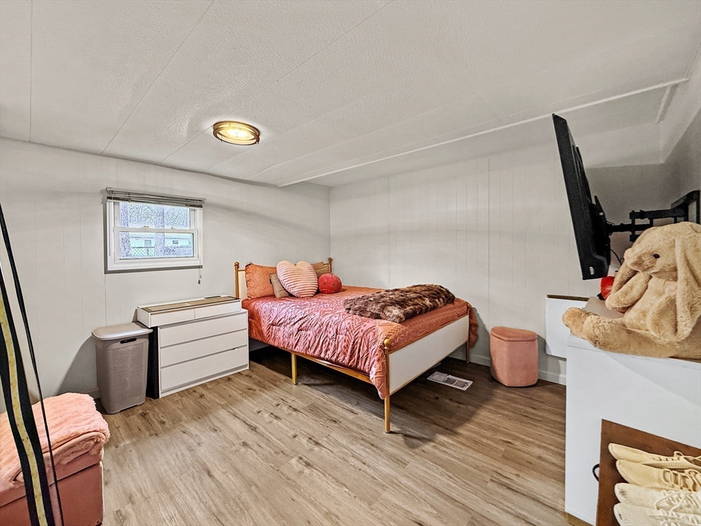 126 Beach Road Salisbury, MA 01952 - Photo 22 of 30 a bedroom with a bed and wooden floor