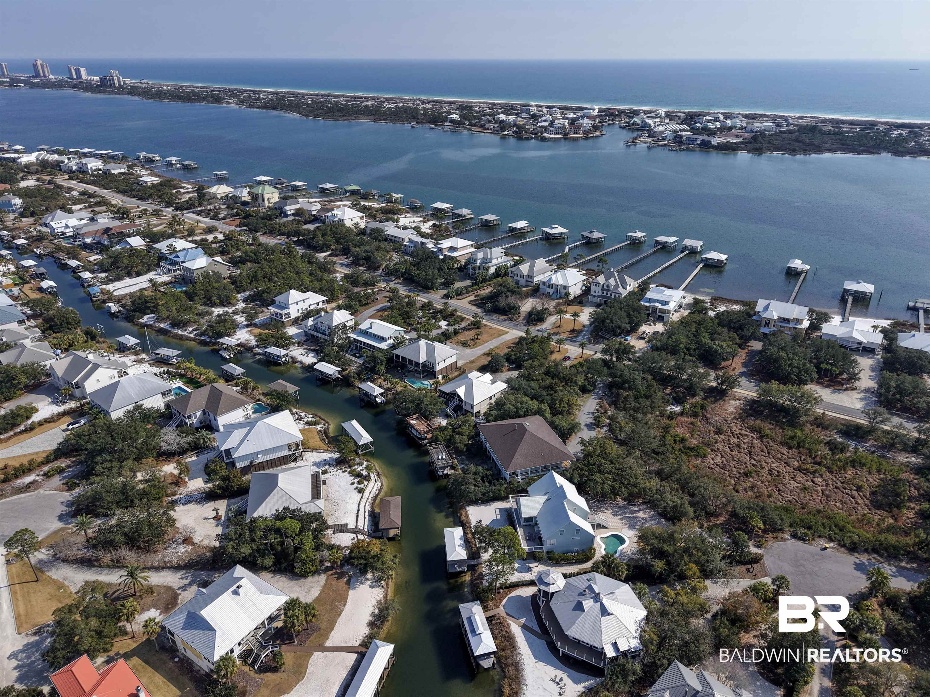 32191 River Road Orange Beach, AL 36561 - Photo 37 of 46 Aerial view of property's location with nearby suburban area and a large body of water