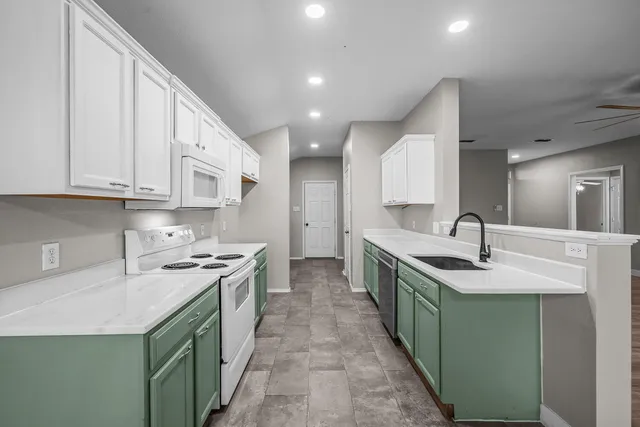 a kitchen with sink a stove and cabinets