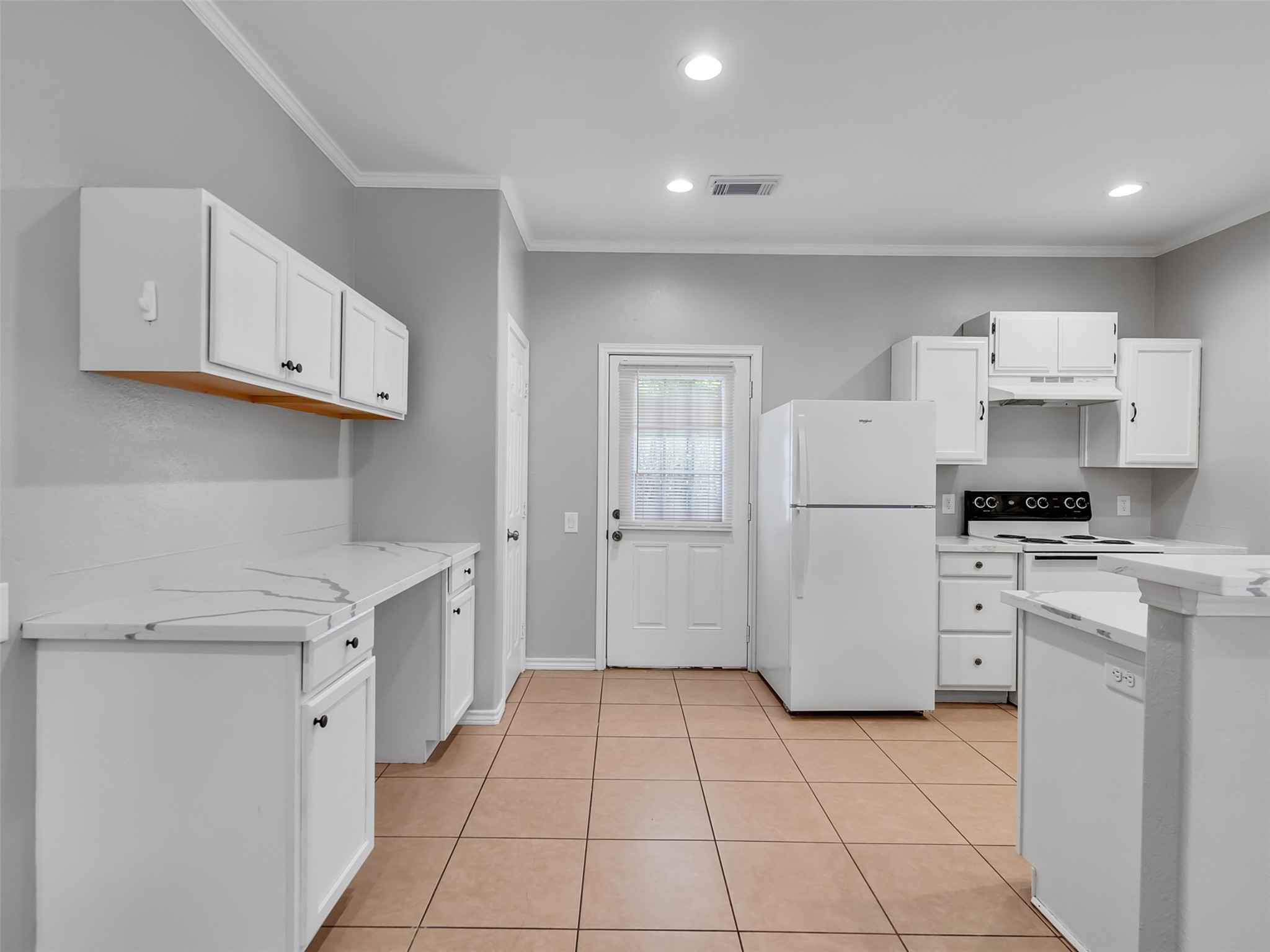 104 Longstreet Road, Unit 2 Willis, TX 77378 - Photo 9 of 26 a kitchen with white cabinets and white appliances
