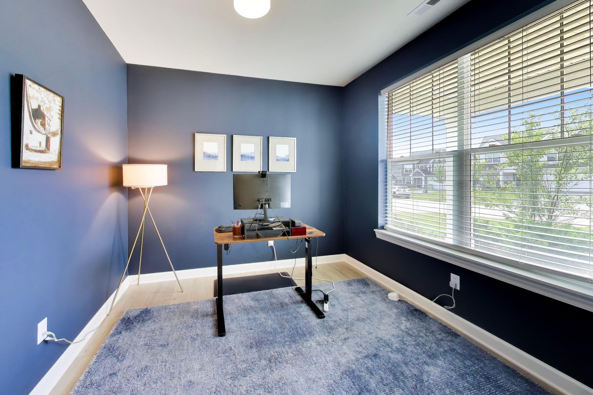 2730 Harbor Court Delavan, WI 53115 - Photo 21 of 47 French-door office with blue accent walls, wide-plank flooring, large window, and front-facing view.