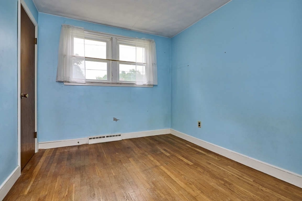 9 Bowman Road Billerica, MA 01821 - Photo 11 of 23 an empty room with wooden floor and windows