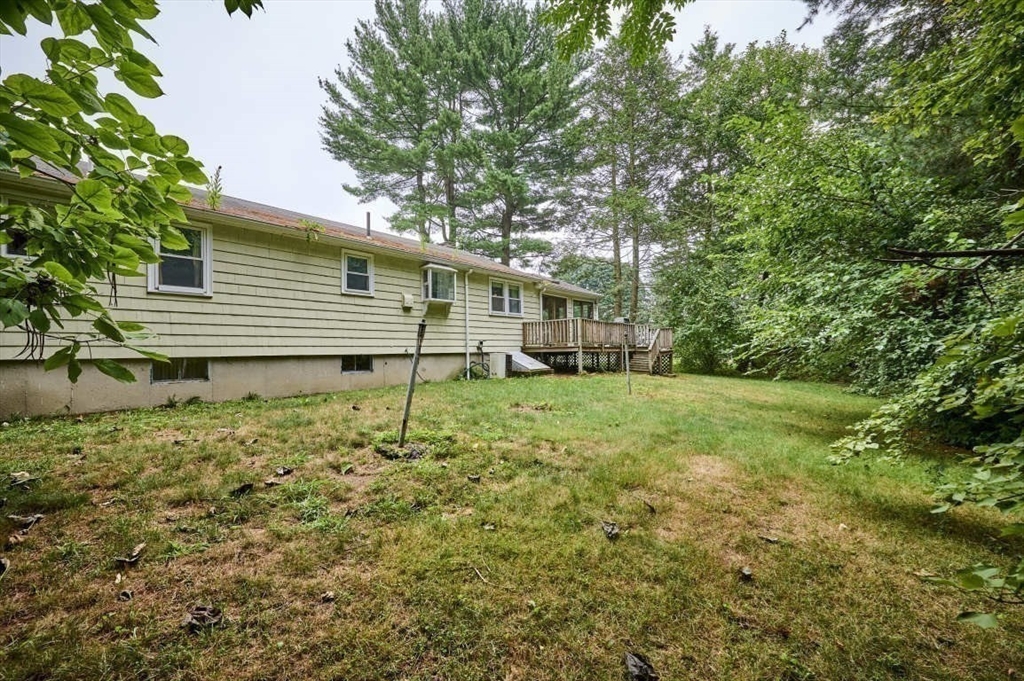 9 Bowman Road Billerica, MA 01821 - Photo 23 of 23 a backyard of a house with plants and large tree