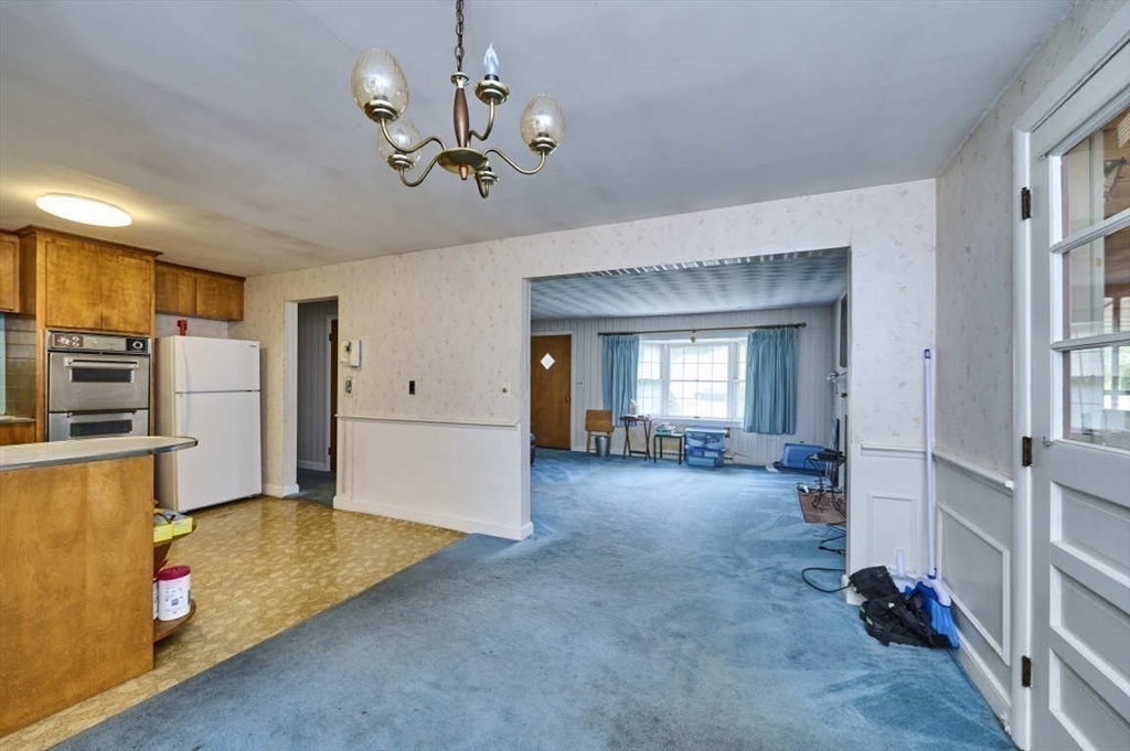 9 Bowman Road Billerica, MA 01821 - Photo 7 of 23 a view of a livingroom with furniture and kitchen view