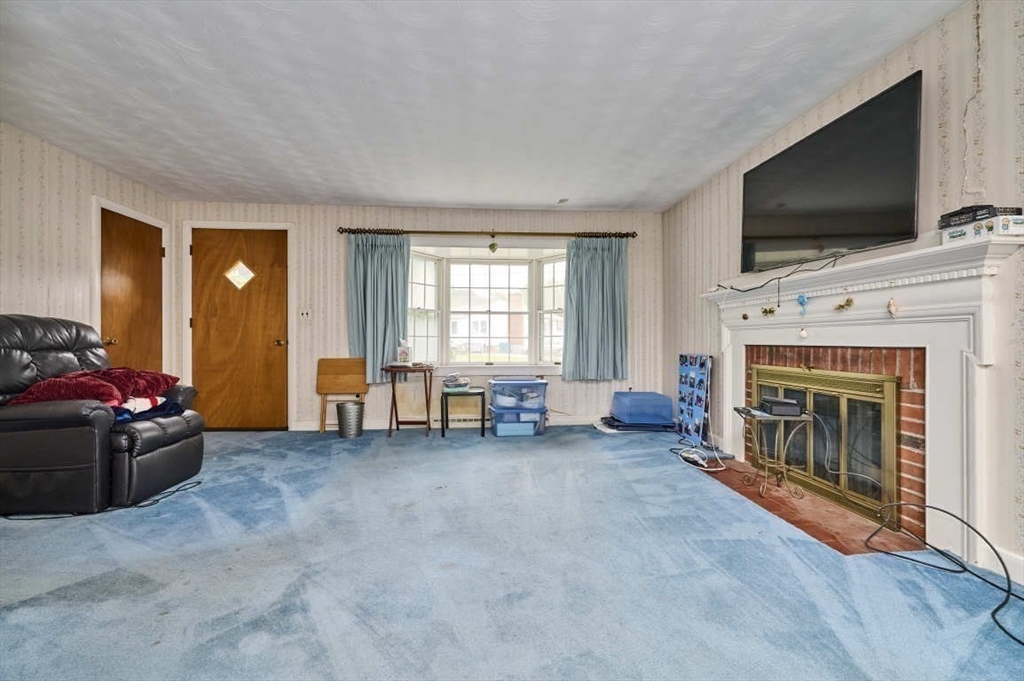 9 Bowman Road Billerica, MA 01821 - Photo 8 of 23 a living room with furniture and a flat screen tv