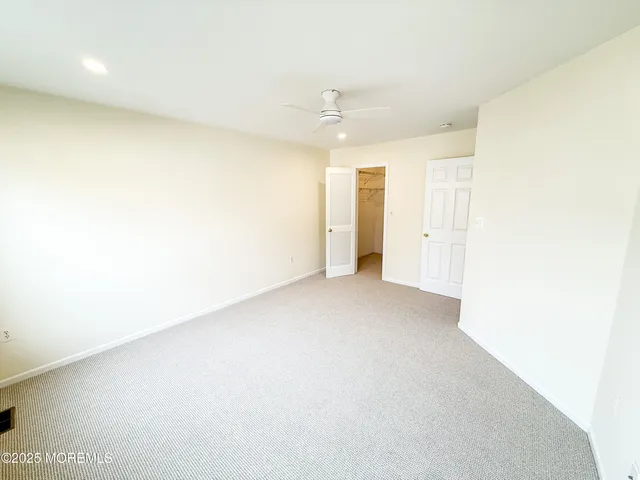 a view of a big room with closet and windows