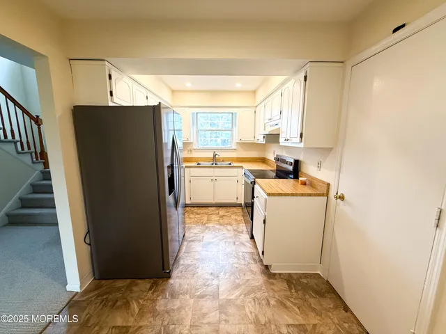 a kitchen with a refrigerator and a sink