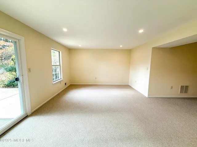 an empty room with a empty space and windows