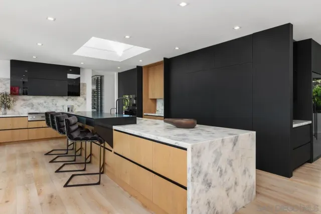 a kitchen with a table chairs refrigerator and microwave