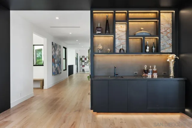 a view of open kitchen with wooden floor and large window