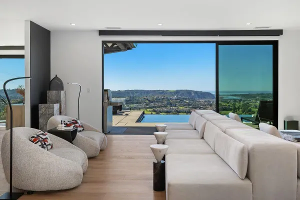 a living room with furniture and a floor to ceiling window
